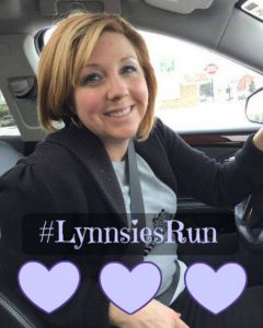 Photo of Lynnsie Feijo sitting in a car. Three purple hearts and "#LynnsiesRun" are overlaid at the bottom.